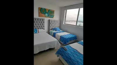 a bedroom with two beds and a window at 2 Bedroom Beachfront Apartment 2P1-Al4 With Pool And WIFI in Cartagena de Indias
