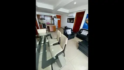 a living room with a table and chairs and a couch at 2 Bedroom Beachfront Apartment 2P1-Al4 With Pool And WIFI in Cartagena de Indias