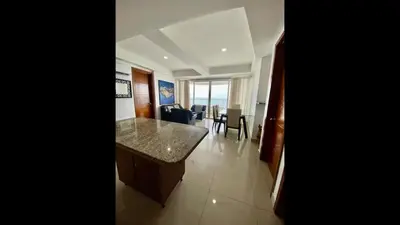 a kitchen and living room with a table and chairs at 2 Bedroom Beachfront Apartment 2P1-Al4 With Pool And WIFI in Cartagena de Indias