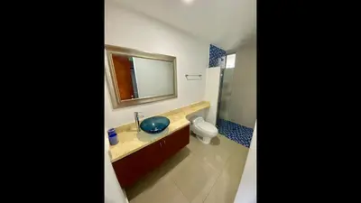 a bathroom with a sink and a toilet and a mirror at 2 Bedroom Beachfront Apartment 2P1-Al2 With Pool And WIFI in Cartagena de Indias