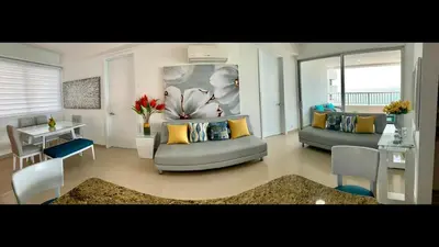 a living room with two couches and a table at 2 Bedroom Beachfront Apartment 2P1-Al2 With Pool And WIFI in Cartagena de Indias