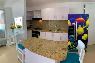 a kitchen with white cabinets and a counter top at 2 Bedroom Beachfront Apartment 2P1-Al2 With Pool And WIFI in Cartagena de Indias