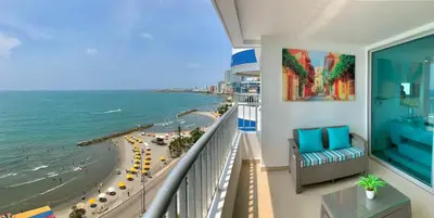 a balcony with a view of the beach and the ocean at 2 Bedroom Beachfront Apartment 2P1-Al2 With Pool And WIFI in Cartagena de Indias
