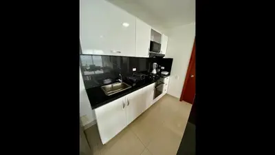a small kitchen with white cabinets and a sink at 2 Bedroom Beachfront Apartment 2P1-Al With Pool And WIFI in Cartagena de Indias