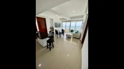 a living room and dining room with a view of the ocean at 2 Bedroom Beachfront Apartment 2P1-Al With Pool And WIFI in Cartagena de Indias