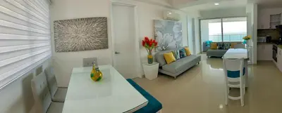 a living room with a couch and a table in a room at 2 Bedroom Beachfront Apartment in Cartagena de Indias
