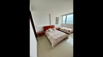 a bedroom with two beds and a window at 2 Bedroom Beachfront Apartment in Cartagena de Indias