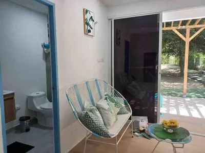 a room with a chair and a toilet and a table at Linda cabaña en Isla Tierra Bomba frente a Cartagena in Cartagena de Indias