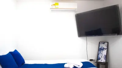a bedroom with a bed and a flat screen tv at Linda cabaña en Isla Tierra Bomba frente a Cartagena in Cartagena de Indias