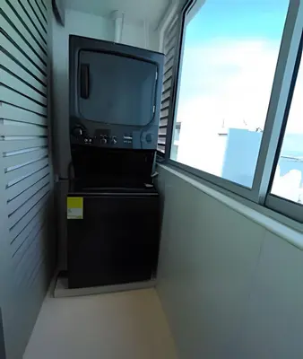 a tv sitting on a dresser in a room with a window at Laurdhomes Palmetto Beach Floor 32, Sea View, 3HBT in Cartagena de Indias