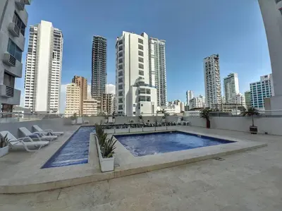 a swimming pool on the roof of a building with a city at Apartamento Amoblado Cartagena in Cartagena de Indias