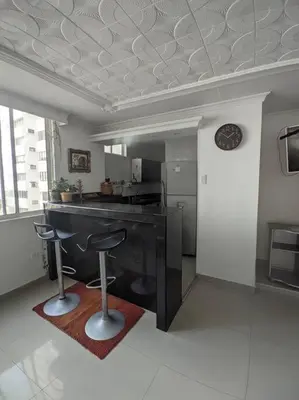 a kitchen with a counter and two bar stools at Apartamento Amoblado Cartagena in Cartagena de Indias