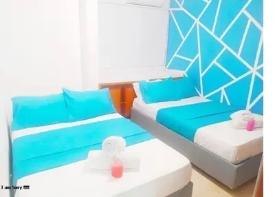 a room with two beds with blue and white at Apartamento con Vista al MAR 11 in Cartagena de Indias
