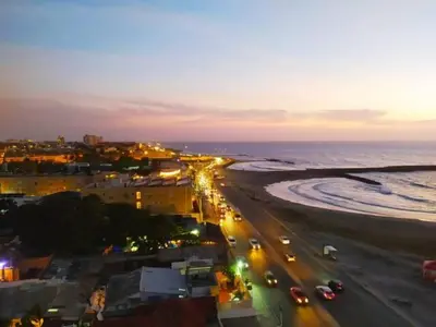 a view of a beach at night with cars at Apartamento con Vista al MAR 11 in Cartagena de Indias