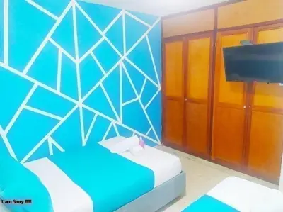 a blue room with a bed and a television at Apartamento con Vista al MAR 11 in Cartagena de Indias