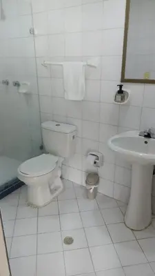 a white bathroom with a toilet and a sink at Apartamento con Vista al MAR 11 in Cartagena de Indias