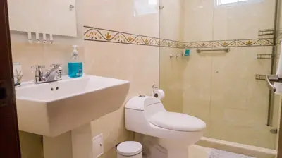 a bathroom with a toilet and a sink and a shower at 2B/2B Gorgeous Sunsets-Ocean View -Pool in Cartagena de Indias