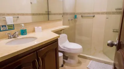 a bathroom with a sink and a shower and a toilet at 2B/2B Gorgeous Sunsets-Ocean View -Pool in Cartagena de Indias