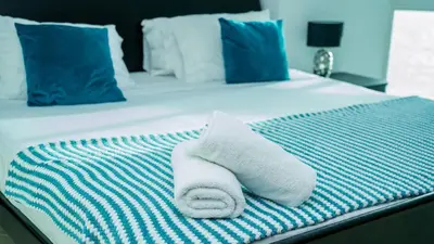 a pile of towels sitting on a bed at 2B/2B Gorgeous Sunsets-Ocean View -Pool in Cartagena de Indias