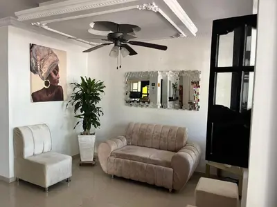 a living room with a couch and a ceiling fan at Hotel Boutique Casa Pere in Cartagena de Indias