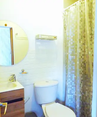 a bathroom with a toilet and a sink and a mirror at Cómodo apartamento cerca al mar. in Cartagena de Indias