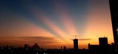 a silhouette of a city with the sun setting at Cómodo apartamento cerca al mar. in Cartagena de Indias