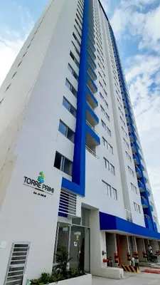 a large white building with a tower firm sign on it at Cómodo apartamento cerca al mar. in Cartagena de Indias
