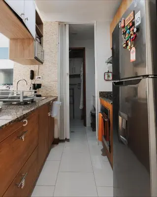 a kitchen with a stainless steel refrigerator and wooden cabinets at Cartagena Apartamento 409 Edf Morros 922 ToLuSa in Cartagena de Indias