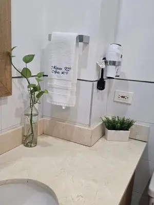 a bathroom with a toilet and a white towel at Cartagena Apartamento 409 Edf Morros 922 ToLuSa in Cartagena de Indias