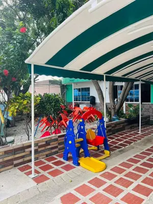 a group of children playing under a tent at Casa Hotel Isabella in Santa Marta