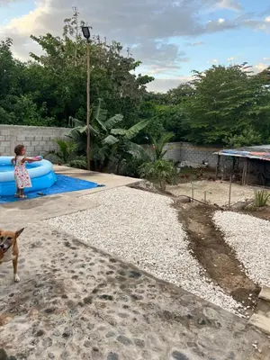 a little girl playing in a pool with a blue raft at Casa Hotel Isabella in Santa Marta