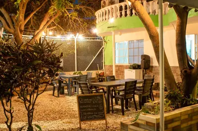 a restaurant with tables and chairs in a courtyard at night at Casa Hotel Isabella in Santa Marta