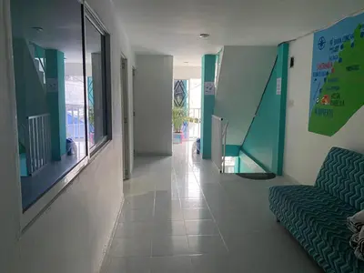 a living room with a couch and a hallway at Casa Hotel Isabella in Santa Marta