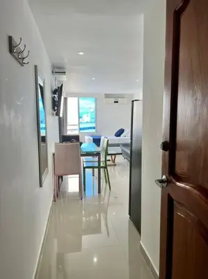 a hallway with a dining room and a dining table at Relax y Confort - Apartamento frente al Mar in Cartagena de Indias