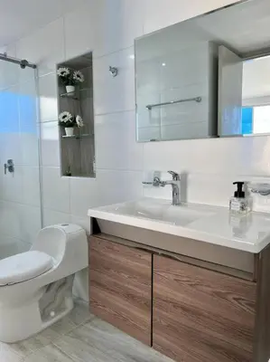 a white bathroom with a sink and a toilet at Relax y Confort - Apartamento frente al Mar in Cartagena de Indias