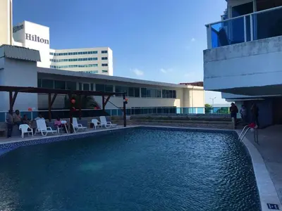 a large swimming pool in front of a building at Relax y Confort - Apartamento frente al Mar in Cartagena de Indias