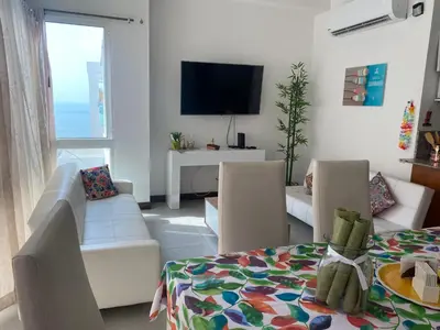 a living room with a couch and chairs and a television at DISFRUTE Y PLAYA in Cartagena de Indias