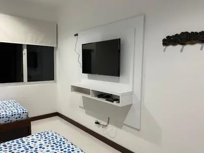 a white room with a tv on a wall at DISFRUTE Y PLAYA in Cartagena de Indias
