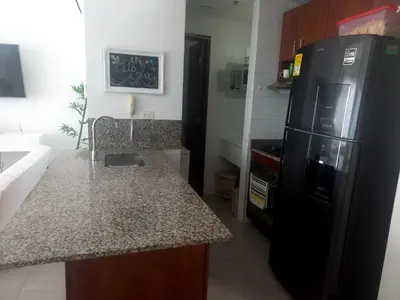 a kitchen with a black refrigerator and a counter at DISFRUTE Y PLAYA in Cartagena de Indias