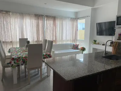 a kitchen and living room with a couch and a table at DISFRUTE Y PLAYA in Cartagena de Indias