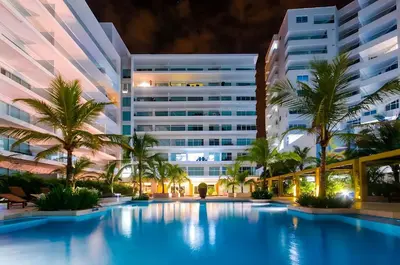 a swimming pool in front of a building at Condominio frente al mar con acceso directo a la playa Morros Epic. in Cartagena de Indias