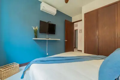a blue bedroom with a bed and a tv at Condominio frente al mar con acceso directo a la playa Morros 922 in Cartagena de Indias