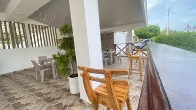 a balcony with chairs and tables on a house at Hostal El Danubio Tolu in Tolú