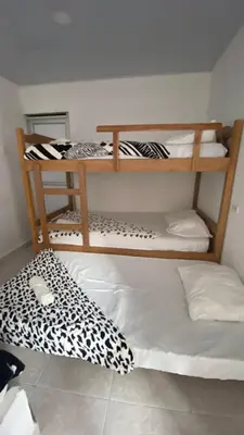 two bunk beds in a room with a bed at Hostal El Danubio Tolu in Tolú