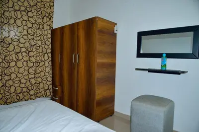 a bedroom with a wooden cabinet and a mirror at Edificio Cristoforo Colombo Apartamento in Cartagena de Indias