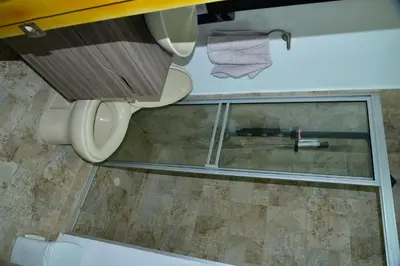 a bathroom with a toilet and a glass window at Edificio Cristoforo Colombo Apartamento in Cartagena de Indias