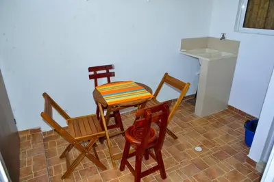a kitchen with three chairs and a table and a sink at Edificio Cristoforo Colombo Apartamento in Cartagena de Indias