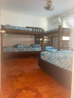 a room with three bunk beds in a room at Casa ISABELLA - Playa dormida in Santa Marta