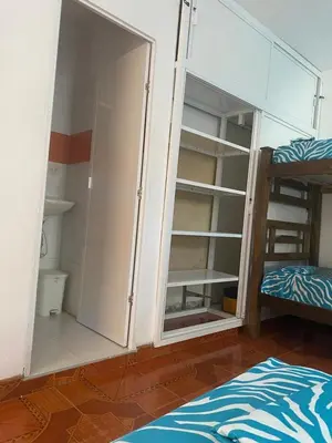 a room with two bunk beds and an open closet at Casa ISABELLA - Playa dormida in Santa Marta
