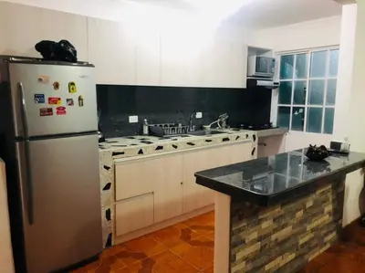 a kitchen with a stainless steel refrigerator and a stove at Casa ISABELLA - Playa dormida in Santa Marta